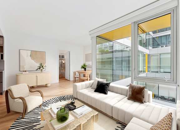 A living room with a white couch and a coffee table.