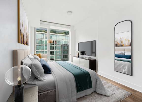 A modern bedroom with a large bed and a flat screen TV.