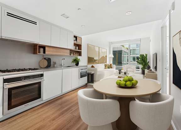 A modern kitchen with a dining table and chairs.
