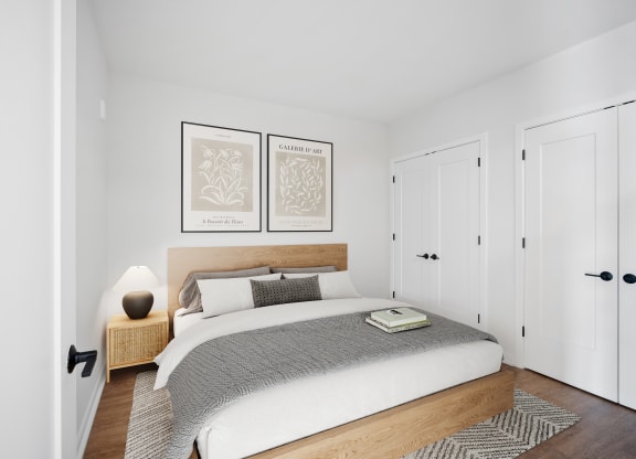 a bedroom with a bed and two white closets