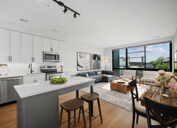 an open living room with a kitchen and a dining room