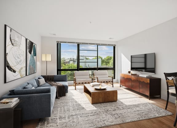 a living room with a couch and a coffee table and a television