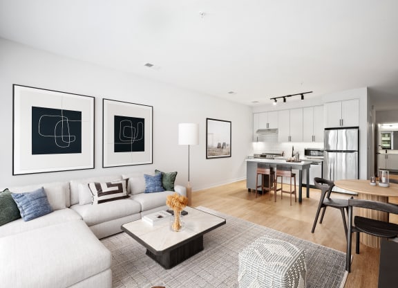 a living room with a couch and a table and a kitchen