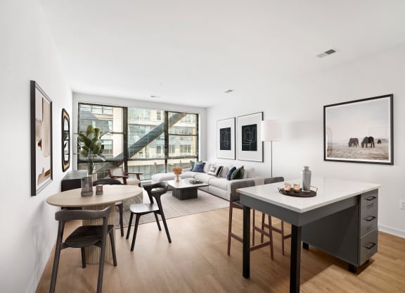 an open living room with a dining room table and a couch