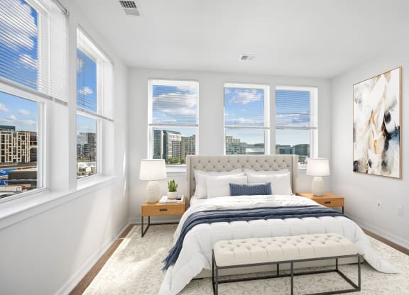a bedroom with a bed and four windows