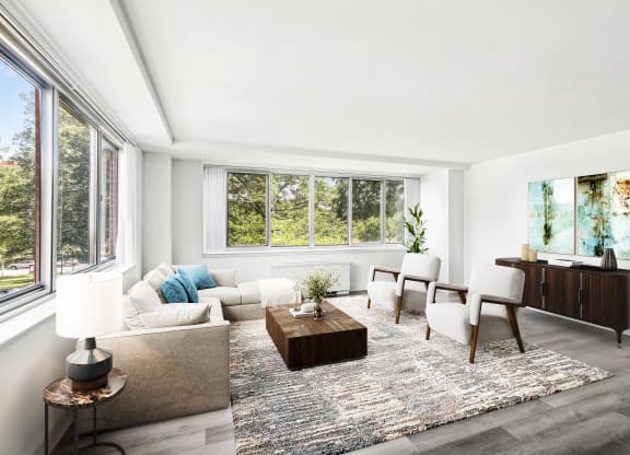 a living room with a couch and chairs and a table