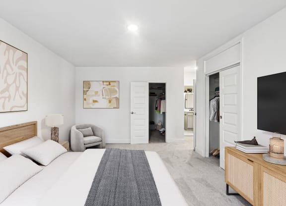 a bedroom with a large bed and a tv