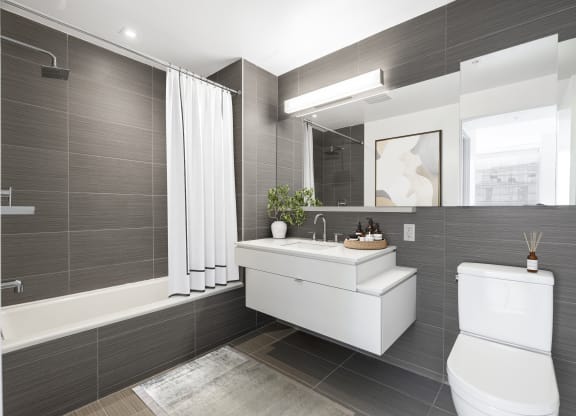 a bathroom with a toilet sink and a mirror