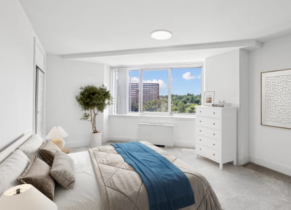a bedroom with a bed and a window