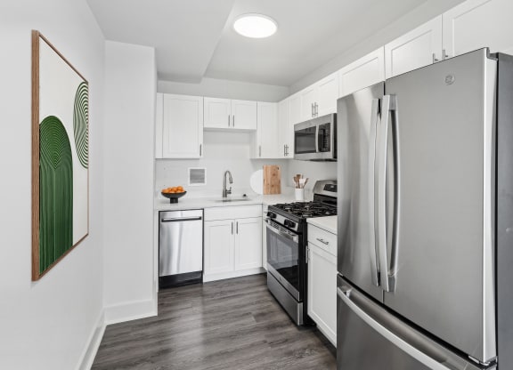 a kitchen with stainless steel appliances and white cabinets