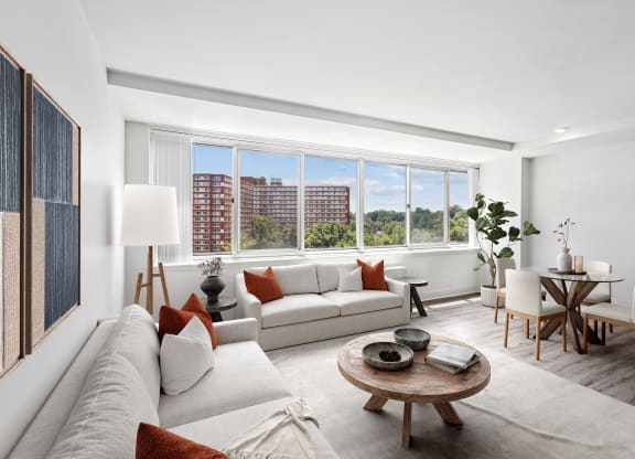 a living room with a couch and a table and a large window