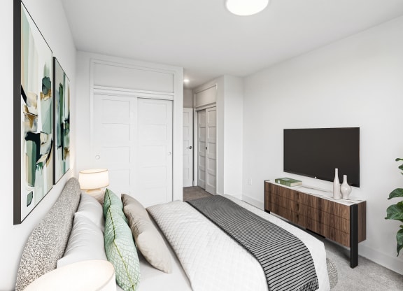 a bedroom with a large bed and a tv