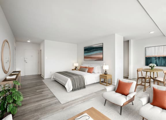 a bedroom with a bed and a table and chairs