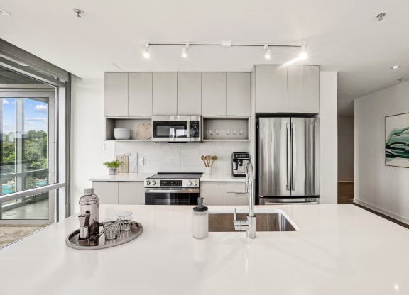 a kitchen with white counter tops and a sink