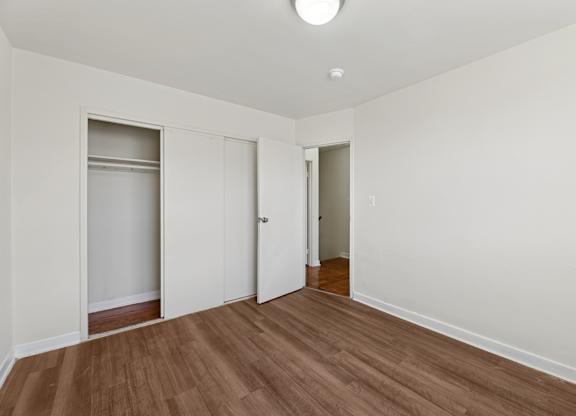 A room with a wooden floor and white walls.
