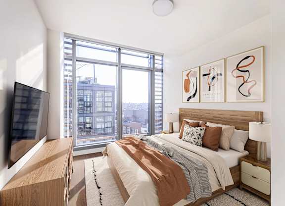 A bedroom with a large bed and a flat screen TV.