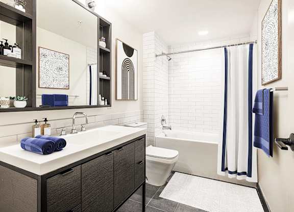 A bathroom with a white sink and a white toilet.