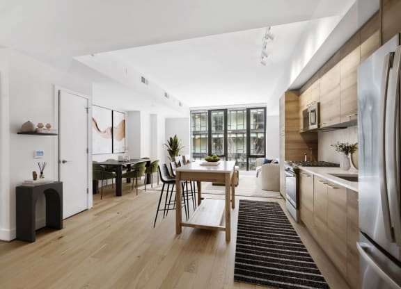 a kitchen and dining area with a wooden table and a refrigerator at The Grace and Reva, Arlington, VA, 22202