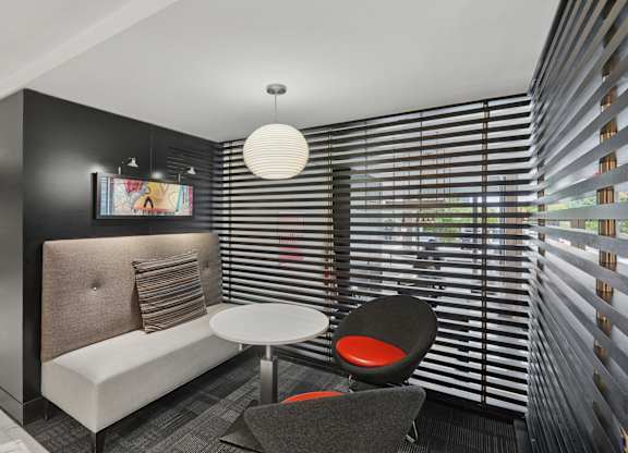 A modern living room with a sofa, chair, and a table.