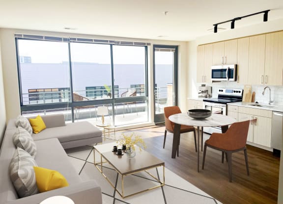 a living room with a couch and a table and a balcony