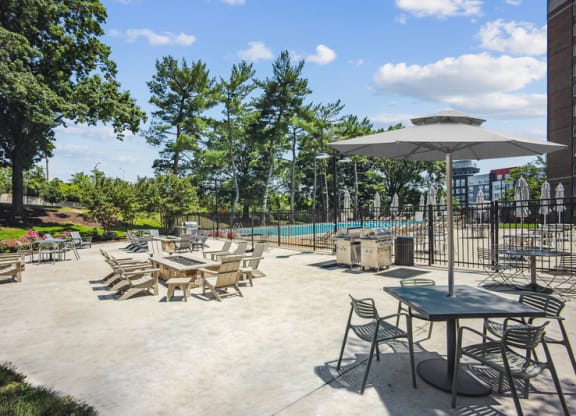 a patio with tables and chairs and a swimming pool