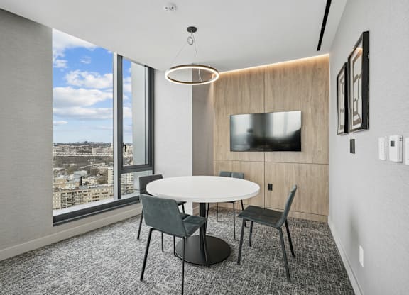 A modern conference room with a large table and chairs.