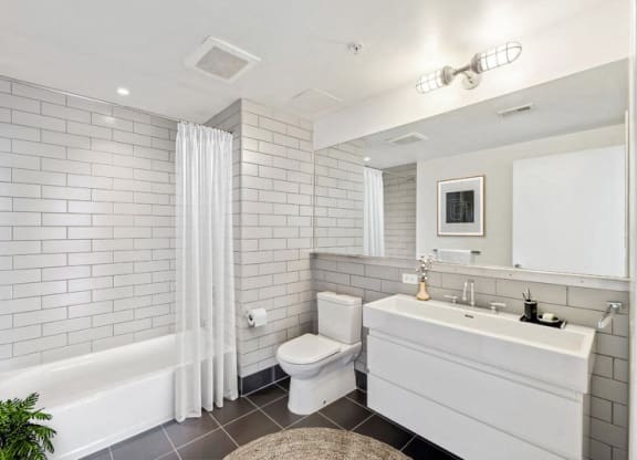 a white bathroom with a toilet and a sink