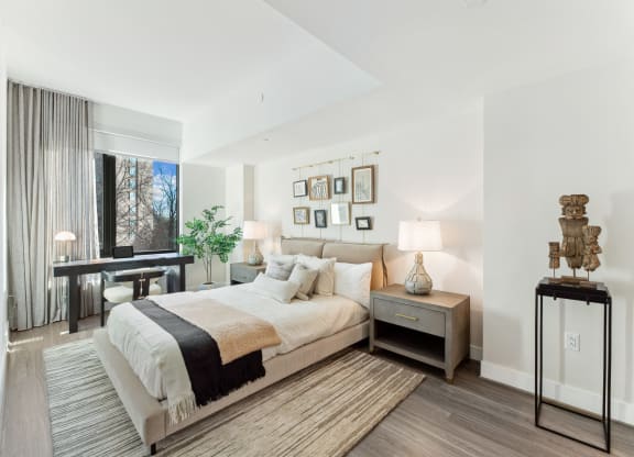 a bedroom with a bed and a desk and a window at The Grace and Reva, Virginia