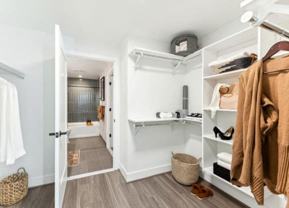 a walk in closet with robes and a shower and a sink at The Grace and Reva, Arlington, VA, 22202