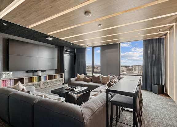 A modern living room with a large couch and a television.