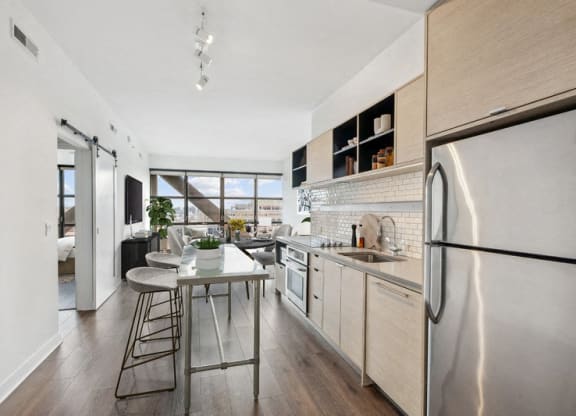 a kitchen with stainless steel appliances and a small table