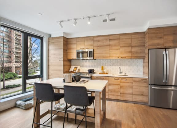 a kitchen with a table and chairs and a refrigerator at The Grace and Reva, Virginia, 22202