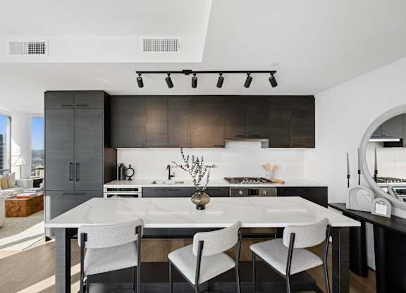 A modern kitchen with a dining table and chairs.