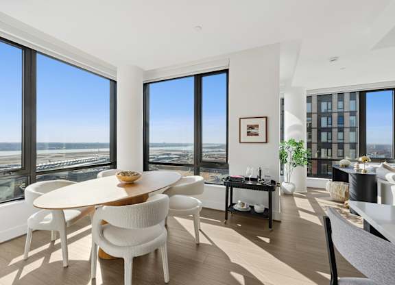 A modern dining room with a round table and chairs.