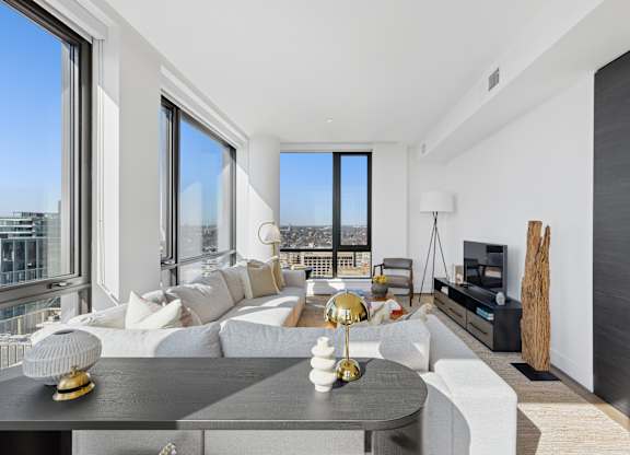 A modern living room with a large window overlooking the city.