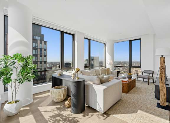 A modern living room with a large window overlooking the city.