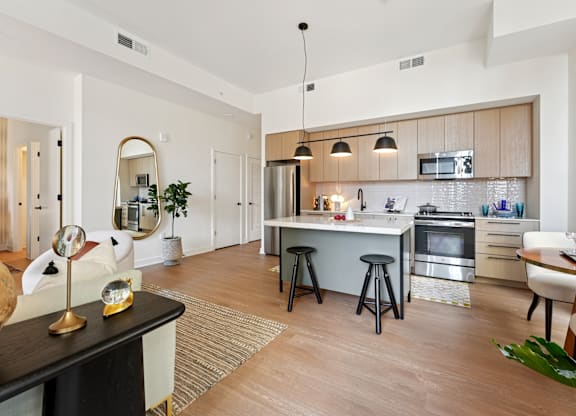A modern kitchen with a dining table and chairs.