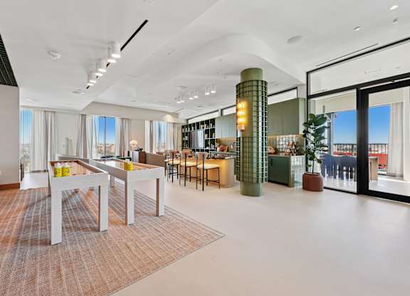A modern dining room with a long table and chairs.