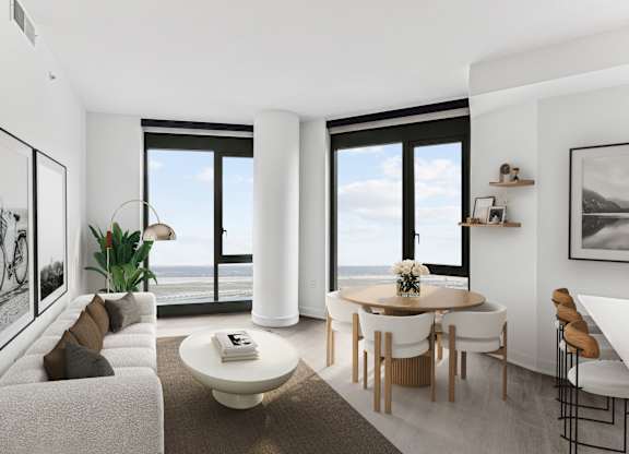 A modern living room with a large window overlooking the ocean.