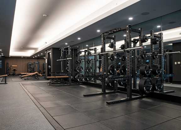 A gym with a variety of weightlifting equipment.