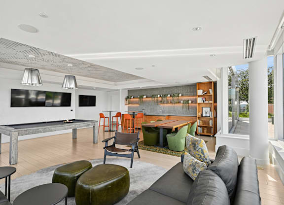 A modern living room with a grey sofa and a wooden coffee table.