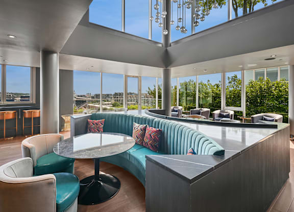 A modern lounge area with a curved sofa and a round table.