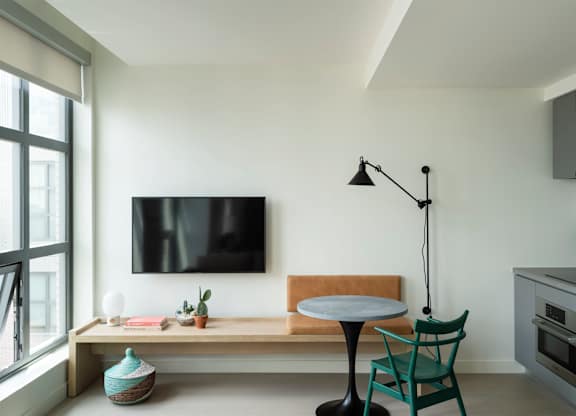 A modern living room with a flat screen TV mounted on the wall.