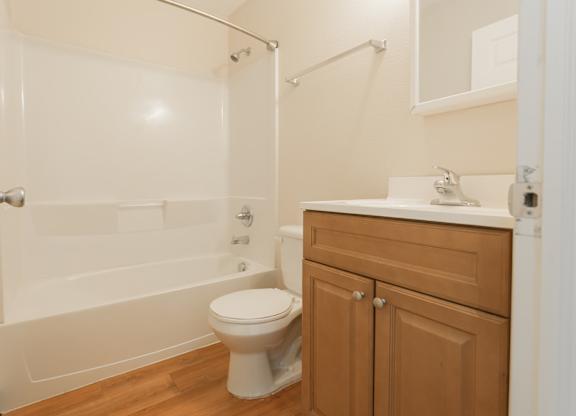 A white toilet sits next to a sink in a bathroom.