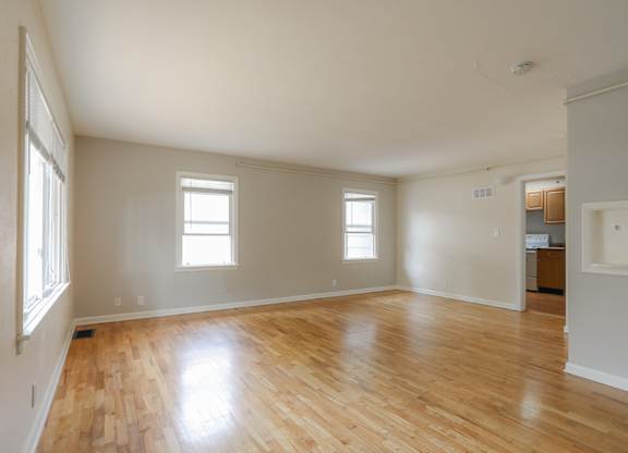 A room with wooden floors and white walls.