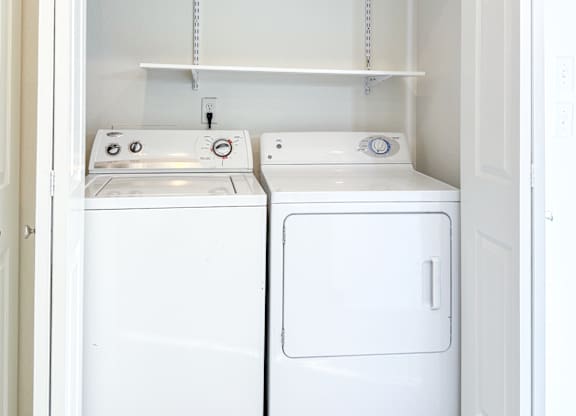 A small laundry room with a washer and dryer.