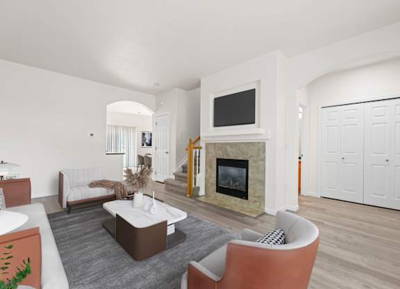 A living room with a fireplace and a television.