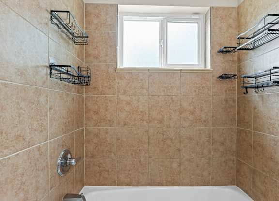 bathroom with a tub at Kingsbrook Arms, Englewood, 80113