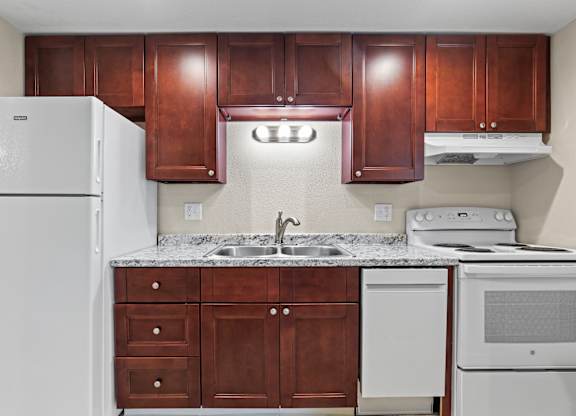 kitchen with brown cabinets at Kingsbrook Arms, Englewood Colorado
