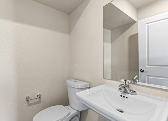 Bathroom with a toilet, sink and a tub at The Townhomes at Pine Drive, Parker
